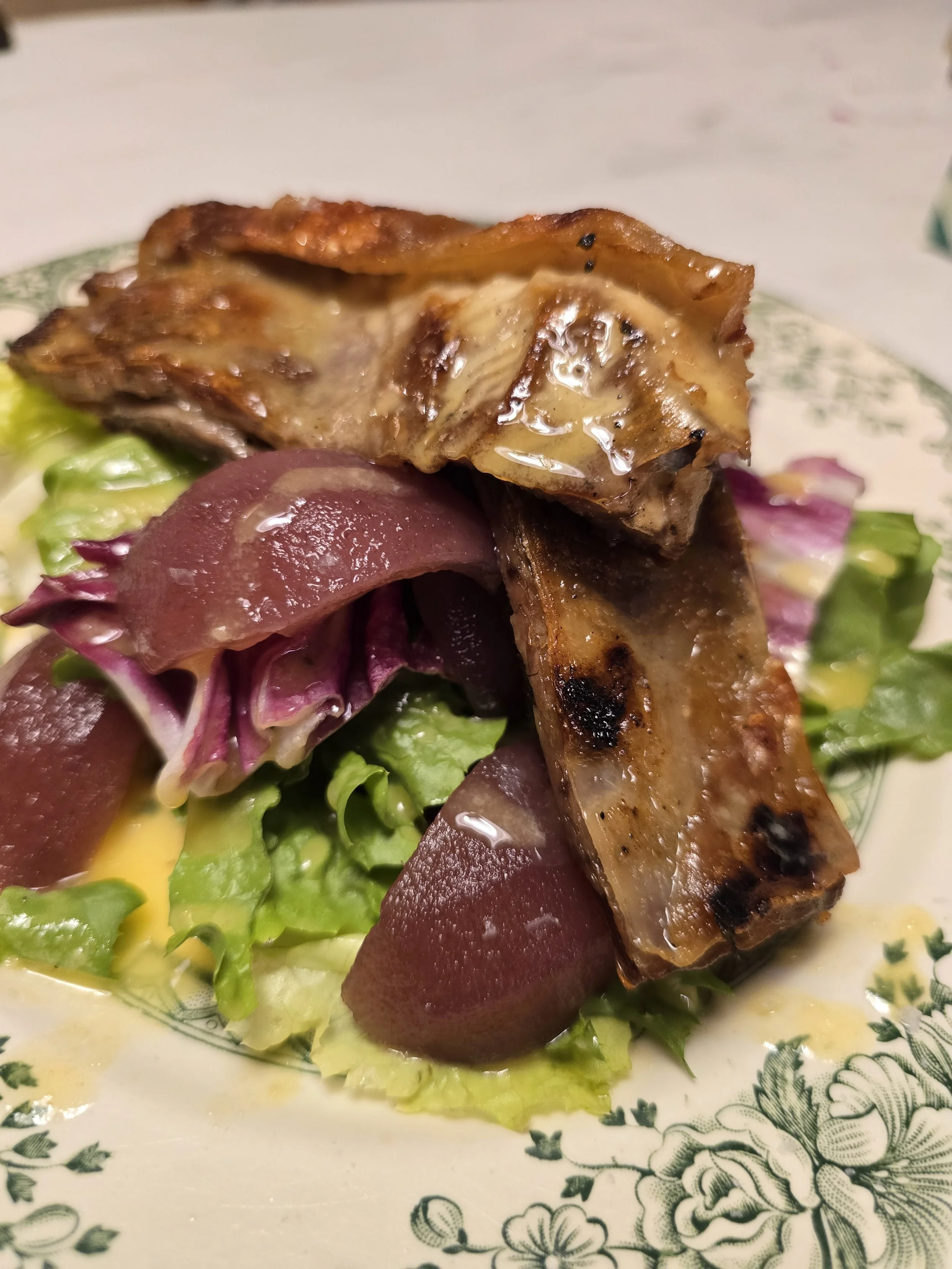 Confit lamb breast with poached pears and bitter leaves