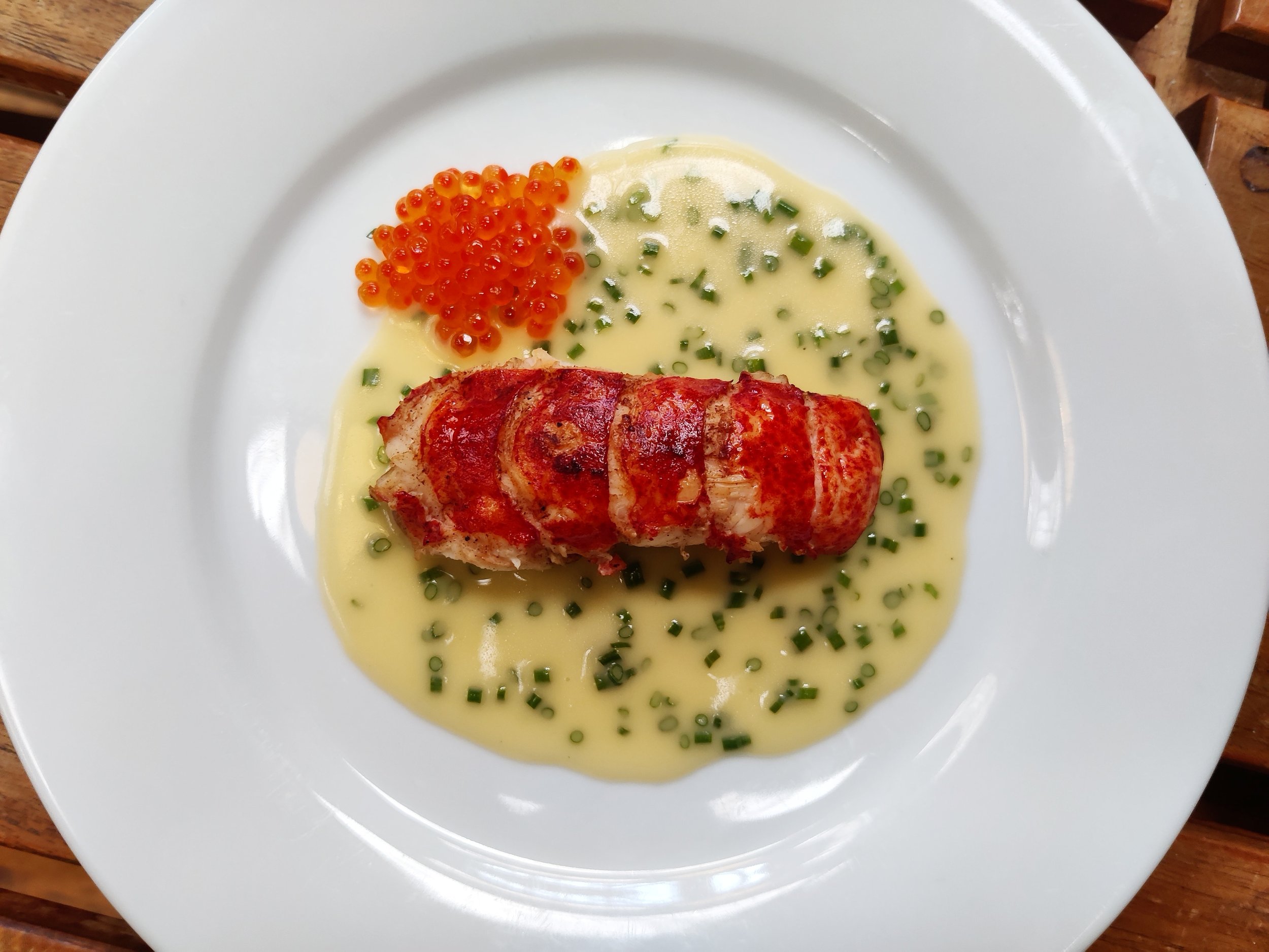 Pan-fried lobster with a chive lemon hollandaise sauce and trout caviar