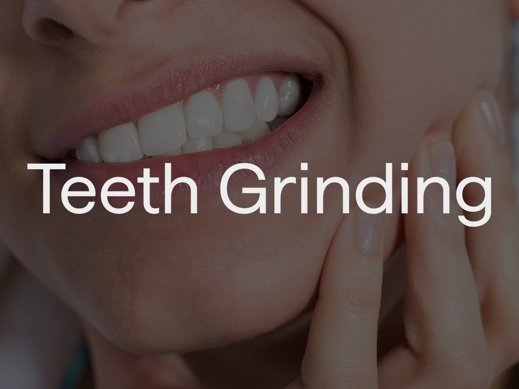 Close-up of a person smiling showing white teeth, with the words "Teeth Grinding" overlayed.