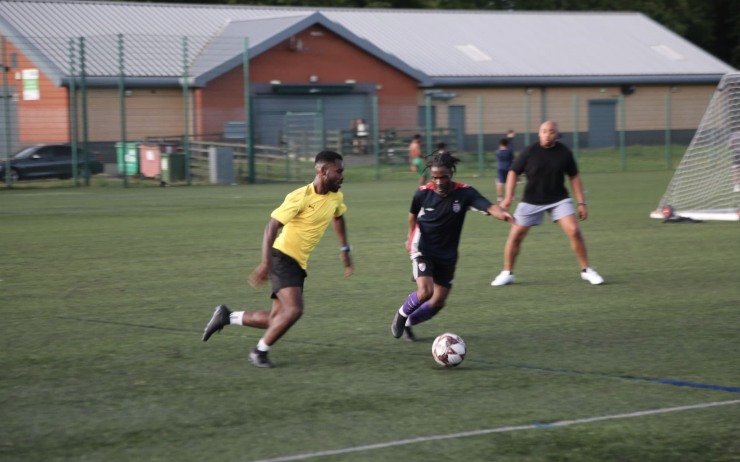 Soccer players competing for ball on field during a game