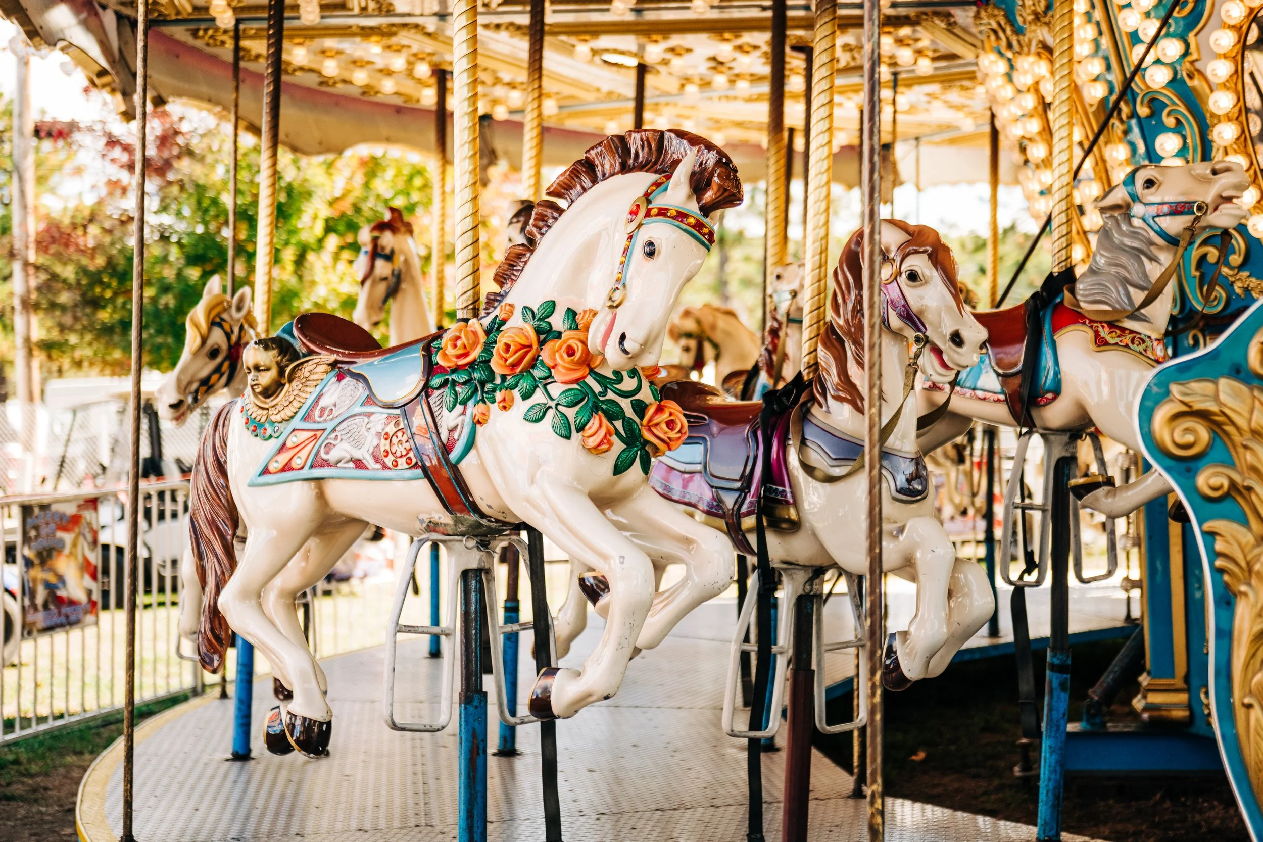 Colorful carousel horses on a merry-go-round at an amusement park.