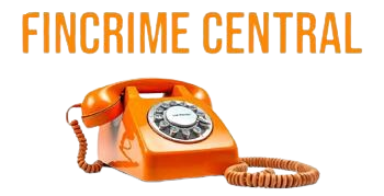 Orange rotary dial telephone with a coiled cord