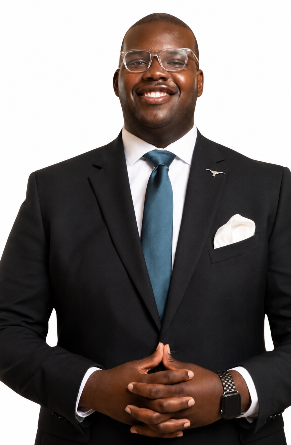 Smiling man with cropped hair,  dark suit and tie.