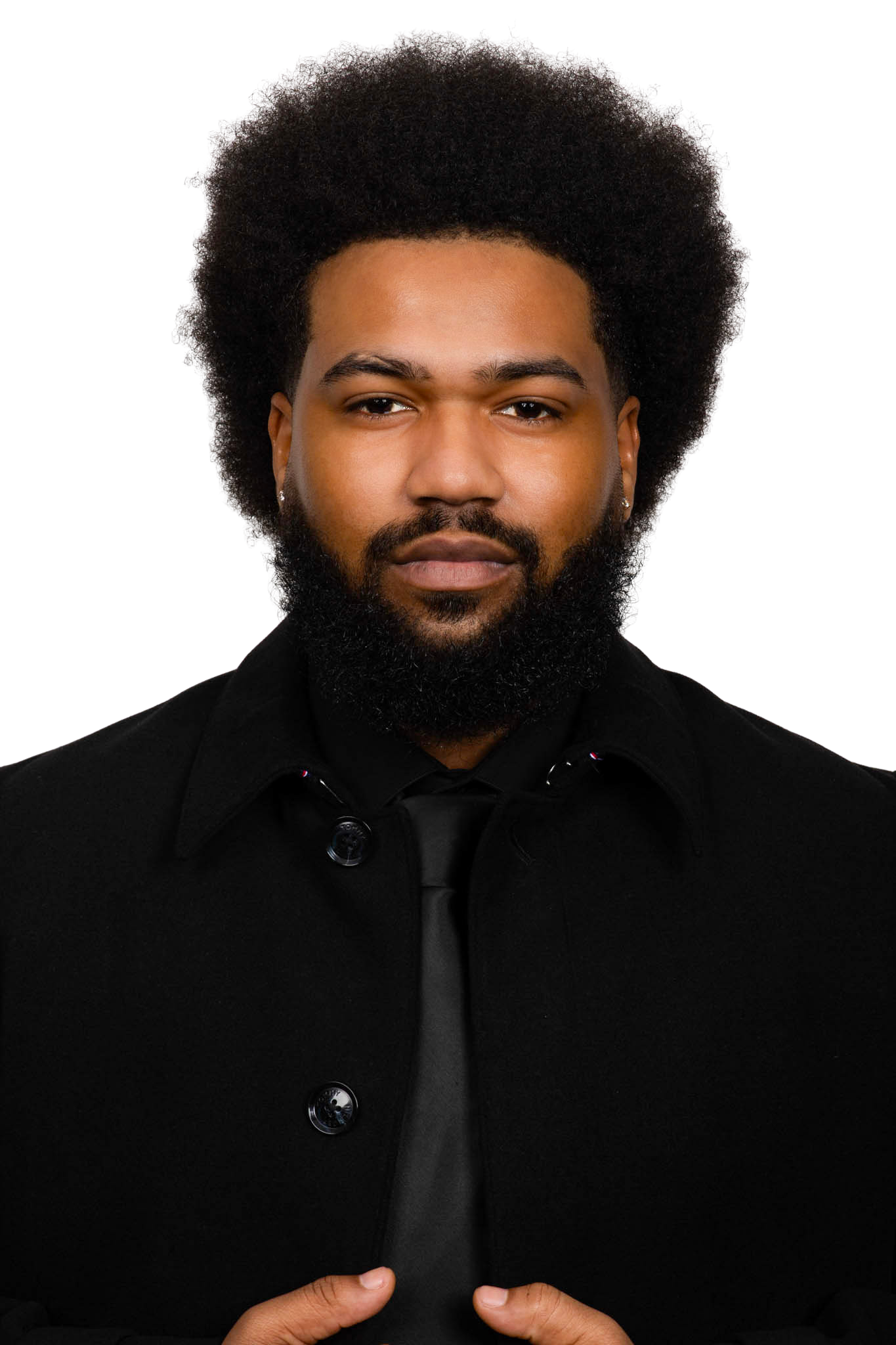 Man in a black suit and tie.