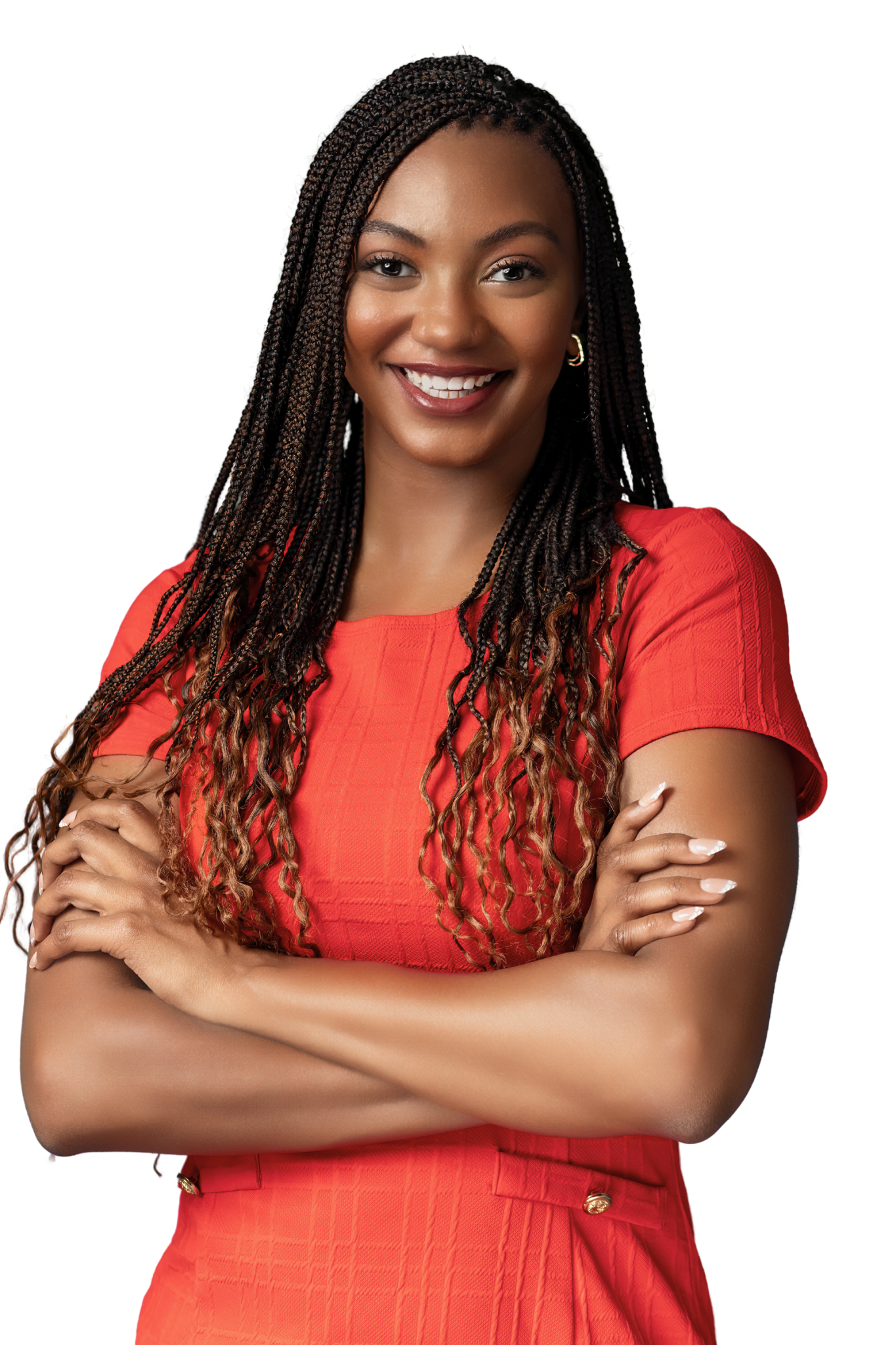 Smiling, beautiful woman with long braids, arms folded across chest and tattoos, wearing a red dress.