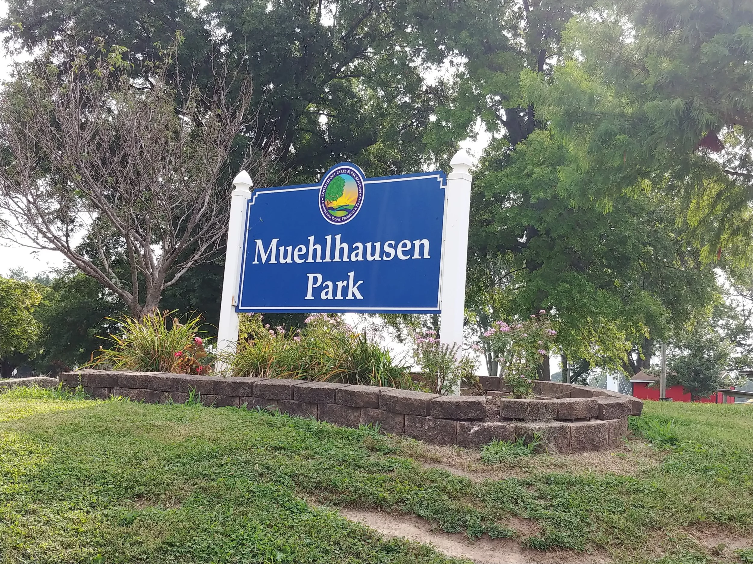 Image contains a blue sign reading "Muehlhausen Park".