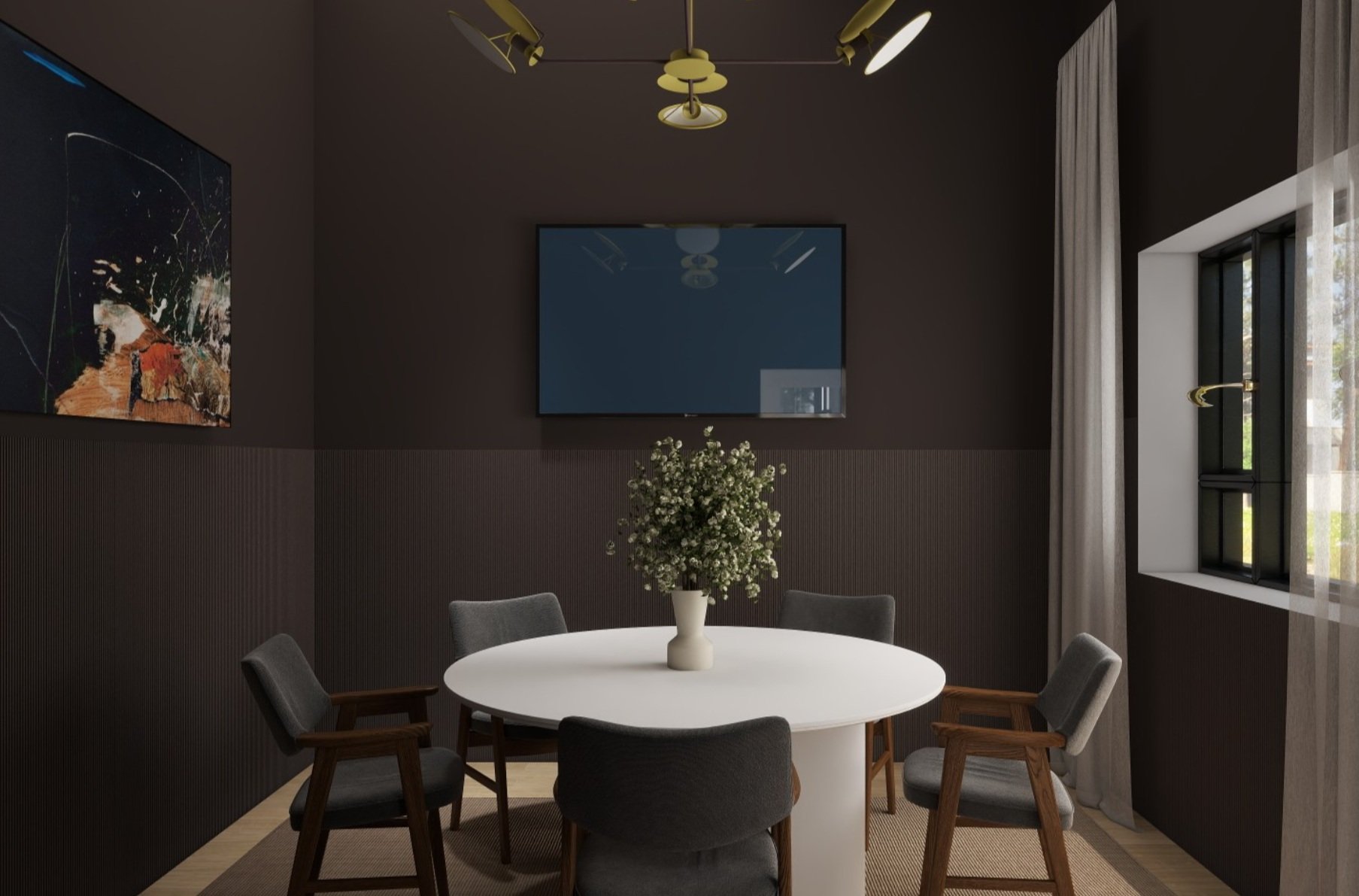 A modern dining room with a round white table, six gray chairs, a centered white vase with flowers, dark wall panels, a window with curtains, a flat-screen TV on the wall, ceiling lights, and an abstract painting.