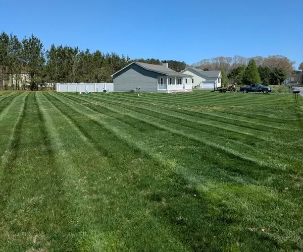 Freshly mowed open lot with attractive stripes in the grass. 
