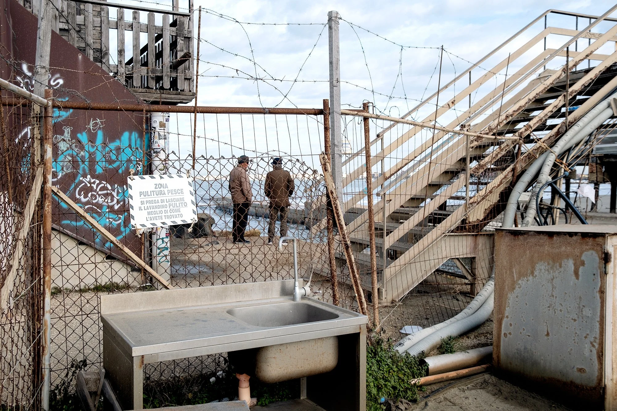 Fishermen at the inlet of the small fishing harbor, 2024