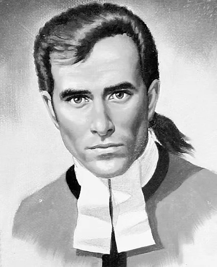 Black and white portrait of a man with medium-length dark hair, wearing a jacket and a white clerical collar, looking directly at the camera with a serious expression.