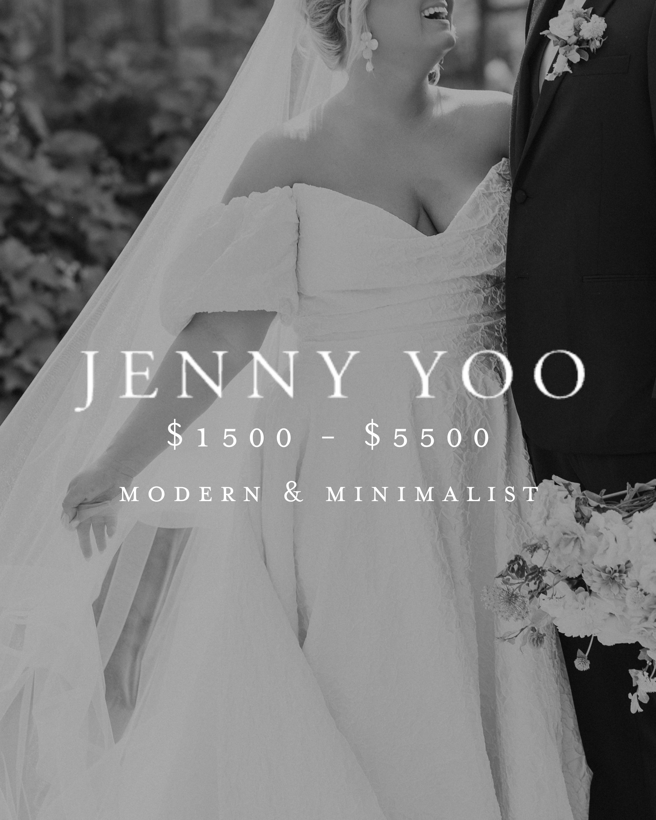 A black and white photograph of a smiling bride and groom during their wedding. The bride is wearing an off-shoulder wedding dress with lace details, and earrings, with a veil. The groom is dressed in a suit with a boutonnière. The background is outdoor and floral decorations are visible.