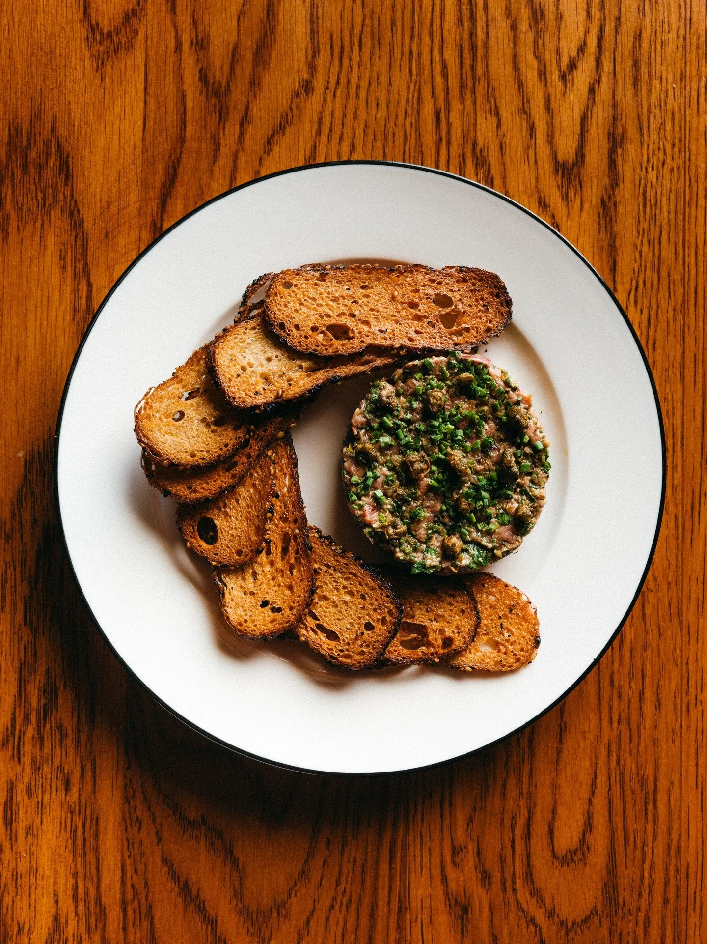 STEAK TARTARE

Hand-cut Petit Filet, Calabrian Chile, Crispy Capers, @mustardsbagels Bagel Chips