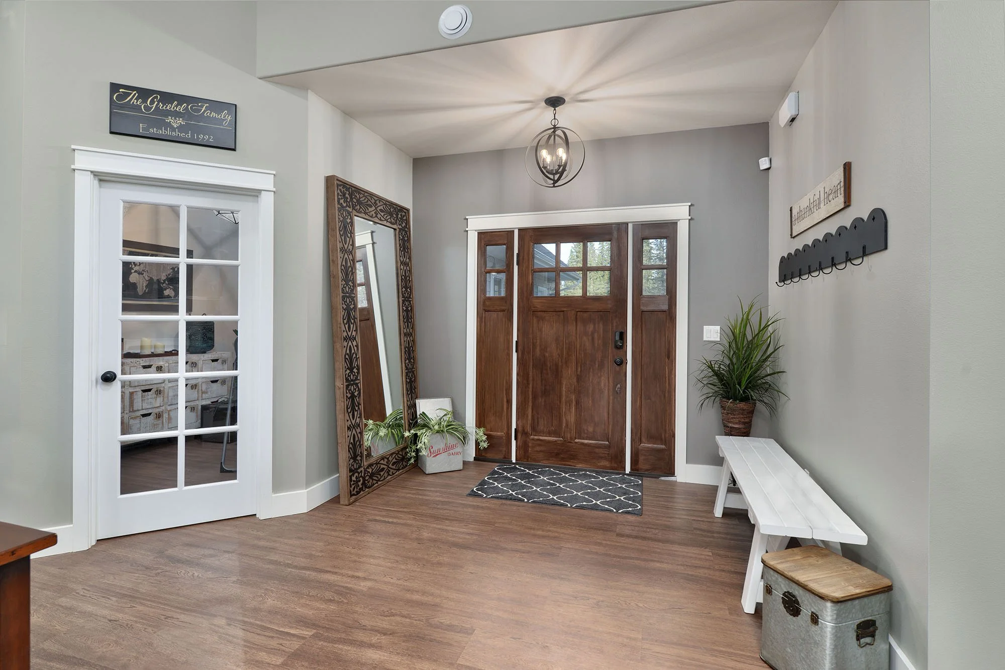 Home entry with wood front door, bench, coat hooks, floor mirror and pendant light - Montana interior design, Designer Interiors