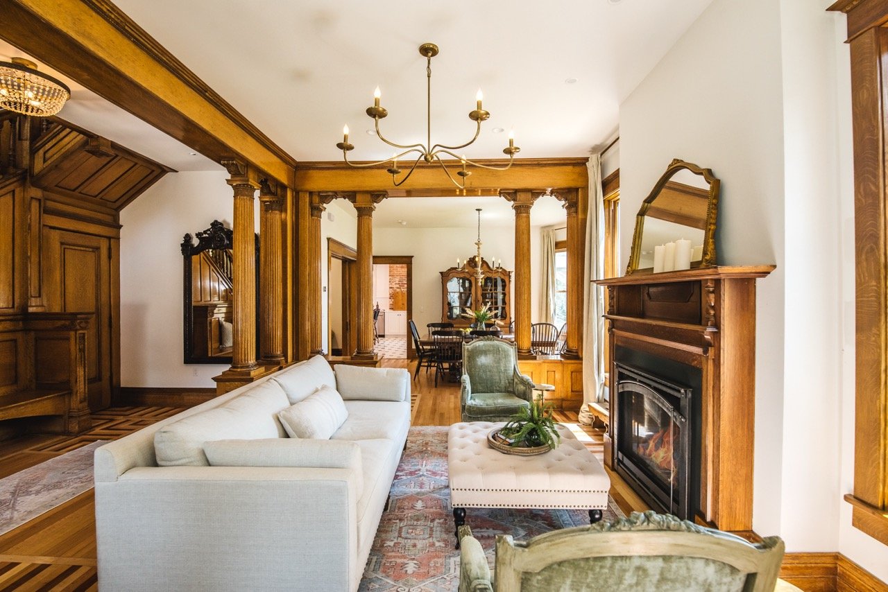 Victorian living room, ornate wood columns, white sofa, Persian rug - Montana interior design, Designer Interiors