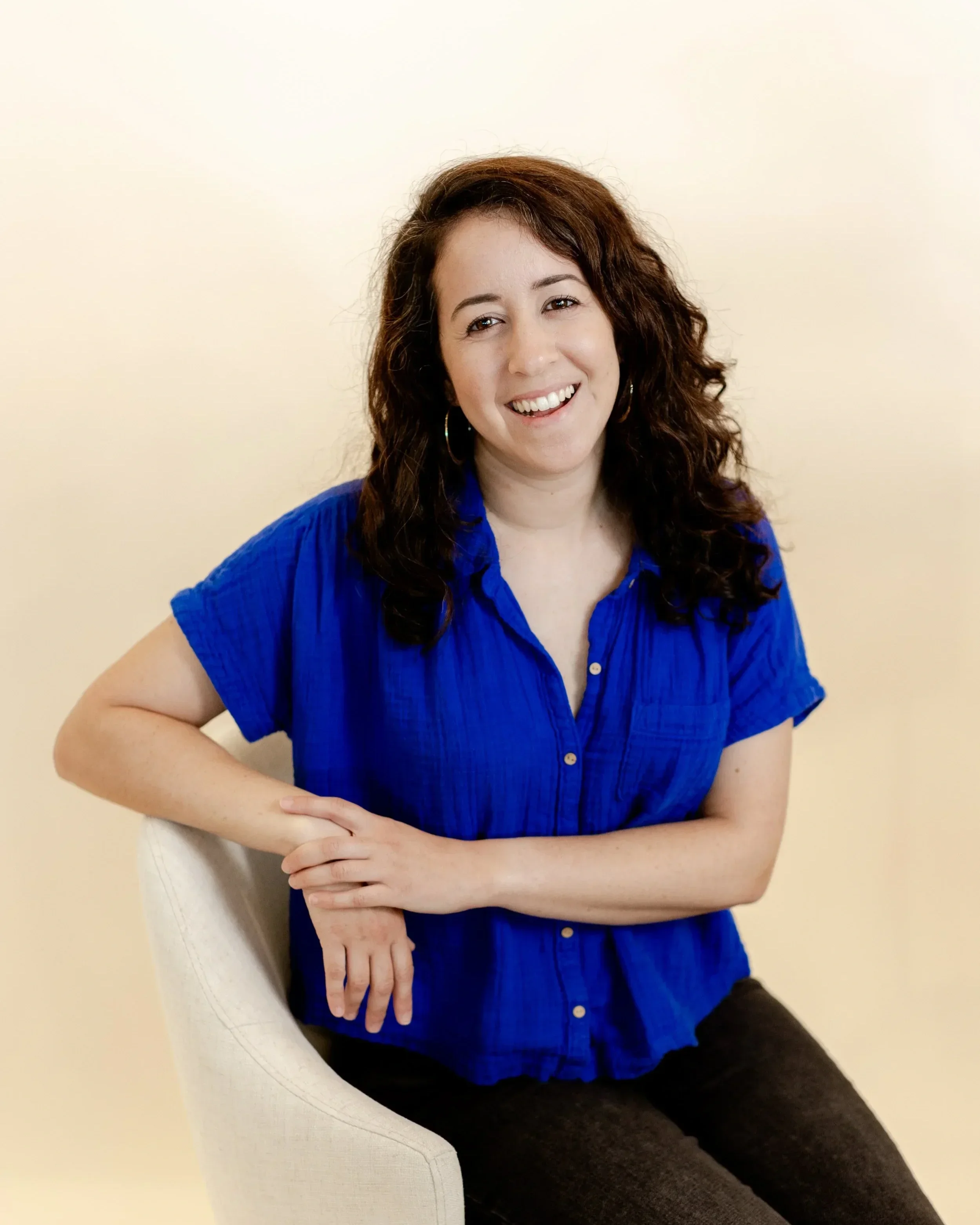 Danit Trau, professional organizer and founder of Sorted Spaces, smiling in a blue shirt.