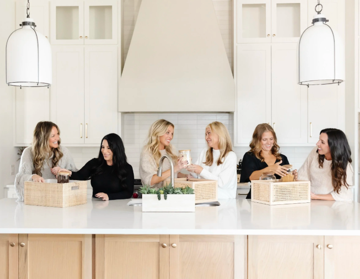 The professional home organizing team of Incredibly Organized, including owner Jamie Kisler, in a modern Dallas kitchen.