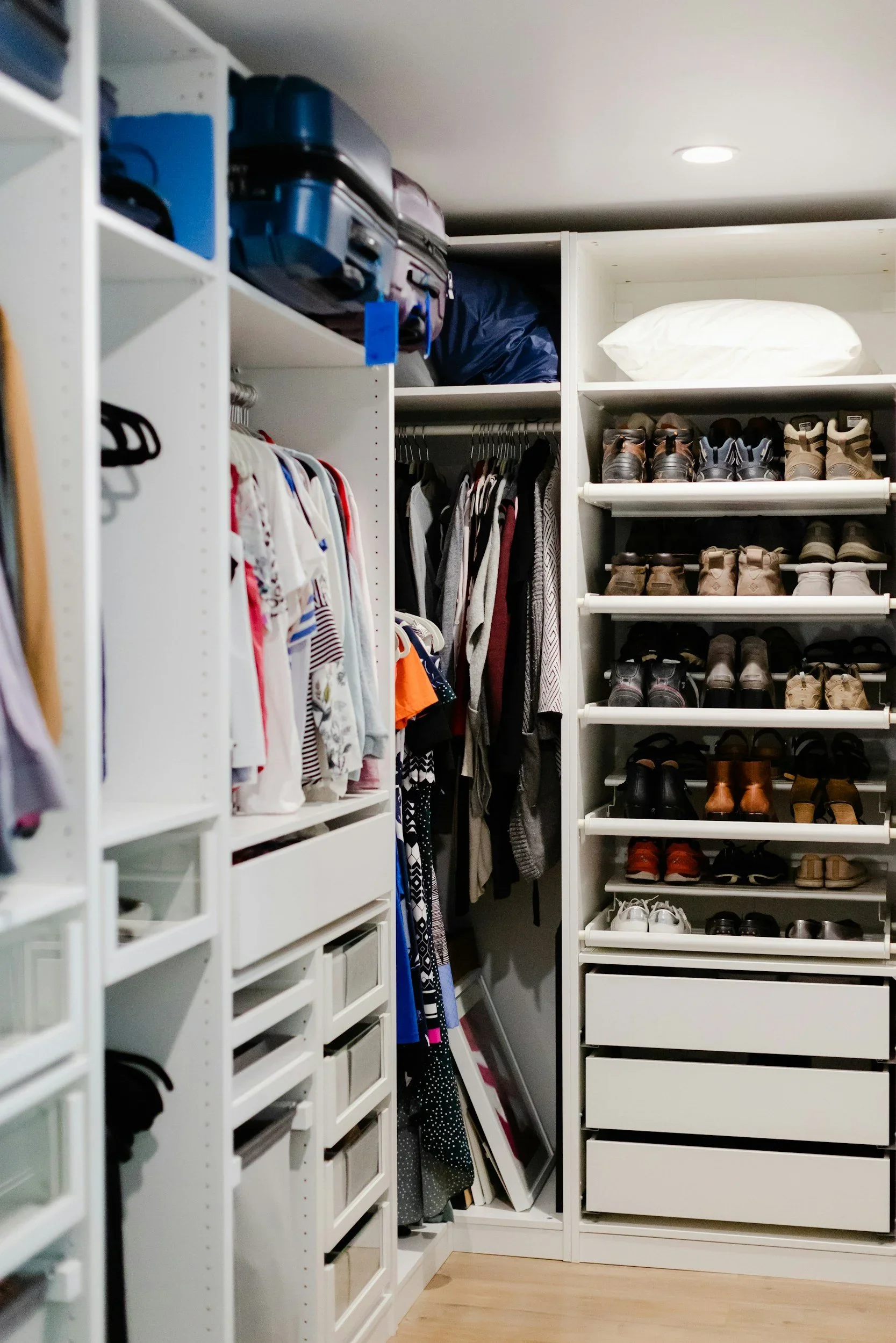 Founder Melissa Klug in a luxury walk-in closet with an Old English Sheepdog.