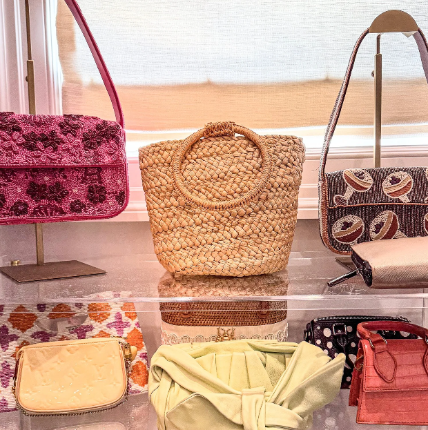 Acrylic shelf dividers organizing a collection of colorful beaded and straw handbags in a Kansas City closet by Organizing Etc.