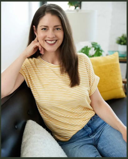Amy Louise, founder of Amy Louise Organizing in Chicago, smiling for a professional headshot in a yellow striped shirt.