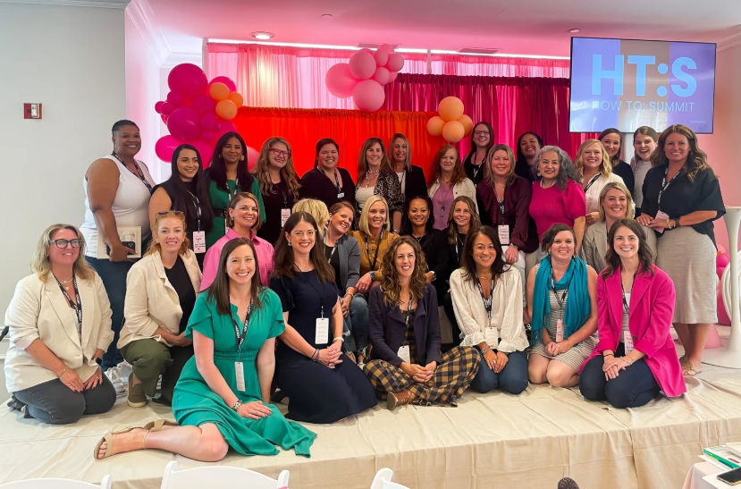 A large group of professional organizers posing together at the Pro Organizer Studio How To Summit event.