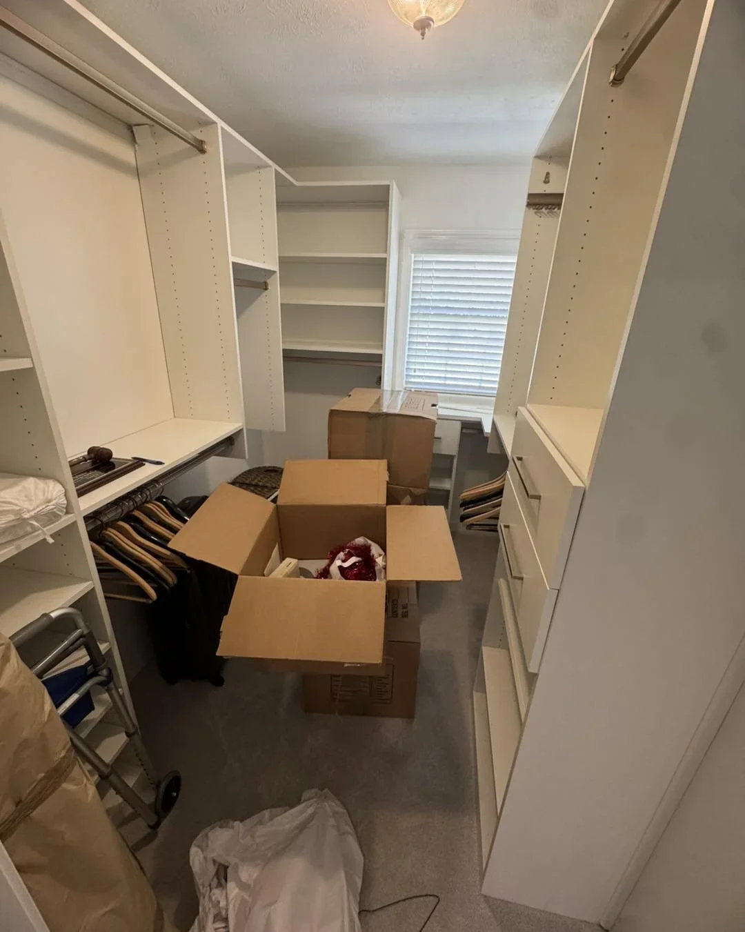 Professional move-in and closet organization in a Georgia home by Delightfully Decluttered, featuring white shelving and boxes.