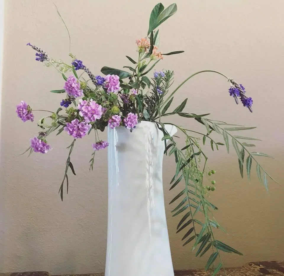 Lavender and wildflowers in a white vase, styled by Room Service Home Organizing in Los Angeles to create a calm, organized home.