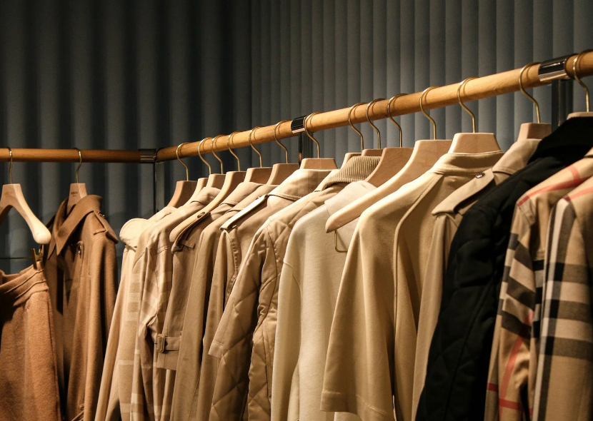 Professional closet organization by Organized with Hope in Carrollton, GA, featuring a color-coordinated clothing collection on a wooden rod.