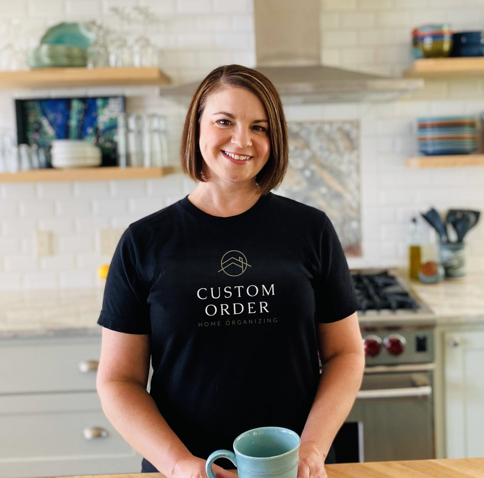 Beth Nordby, founder of Custom Order Home Organizing in the Quad Cities, smiling in a professional kitchen setting.