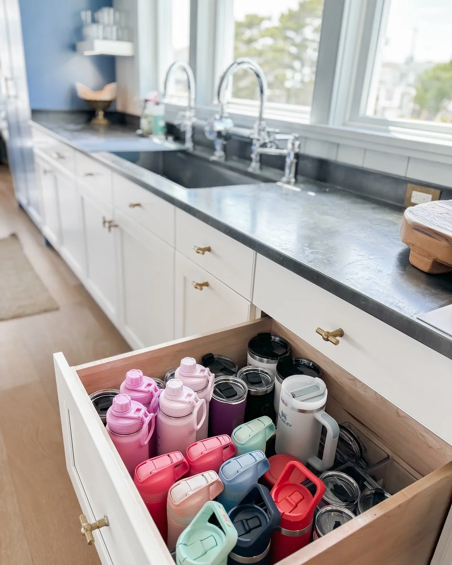 Professional kitchen drawer organization by Orderly at the Shore in Manahawkin, NJ, featuring neatly arranged water bottles and tumblers.
