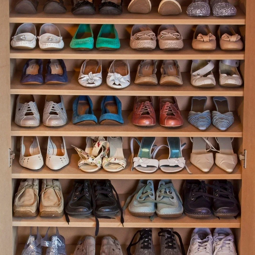 Neatly organized wooden shoe shelves by Second Nature, featuring various styles of heels, flats, and sneakers.
