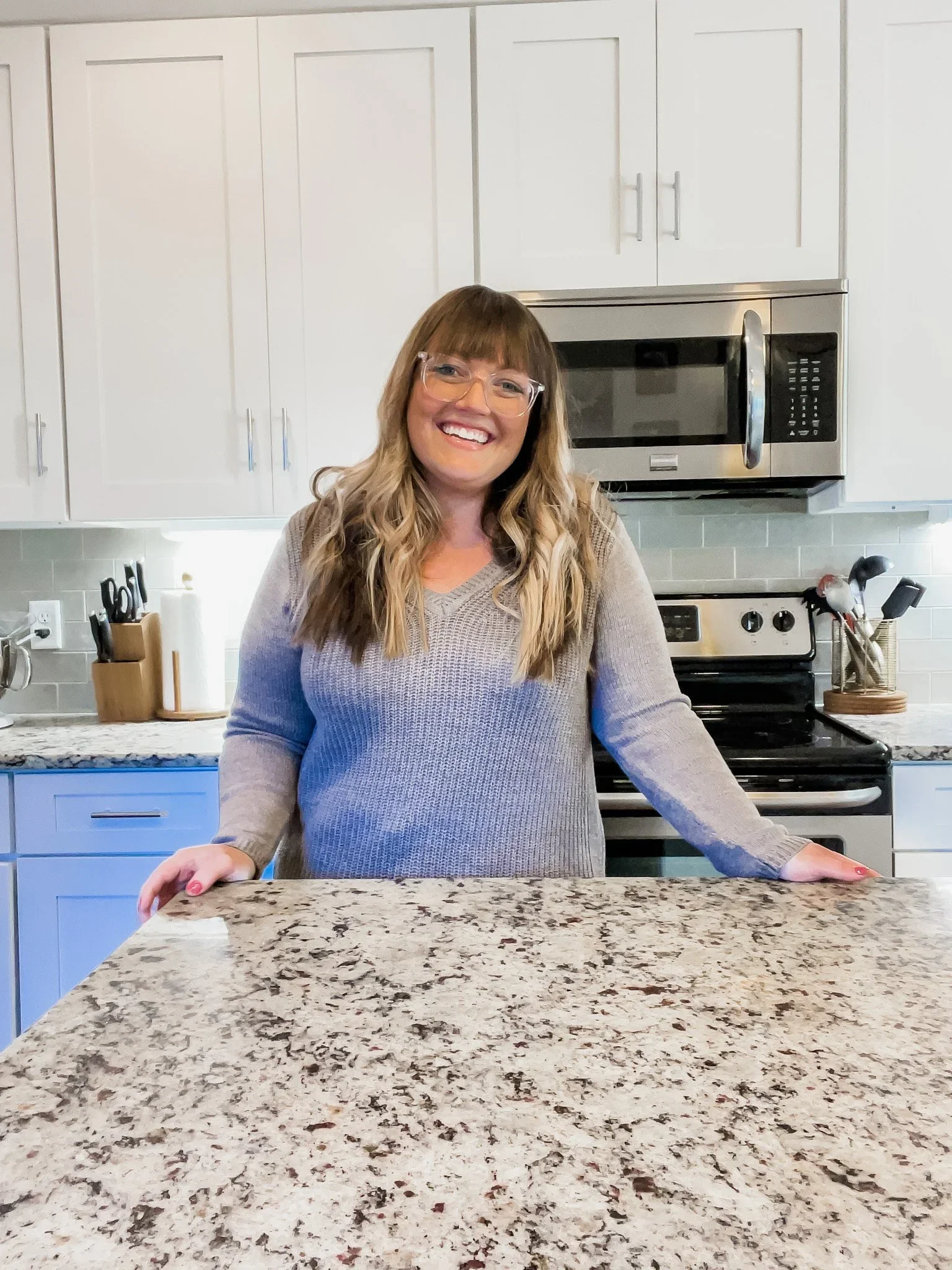 Professional organizer Kyrie Klopke, founder of Refined Living Co., smiling in a bright Nashville kitchen.