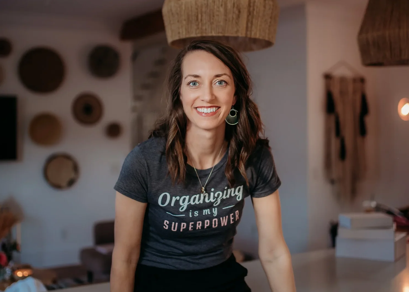 Professional organizer Hope Vance, founder of Organized with Hope, smiling in a grey t-shirt that says 'Organizing is my superpower' in a modern home in Carrollton, GA.