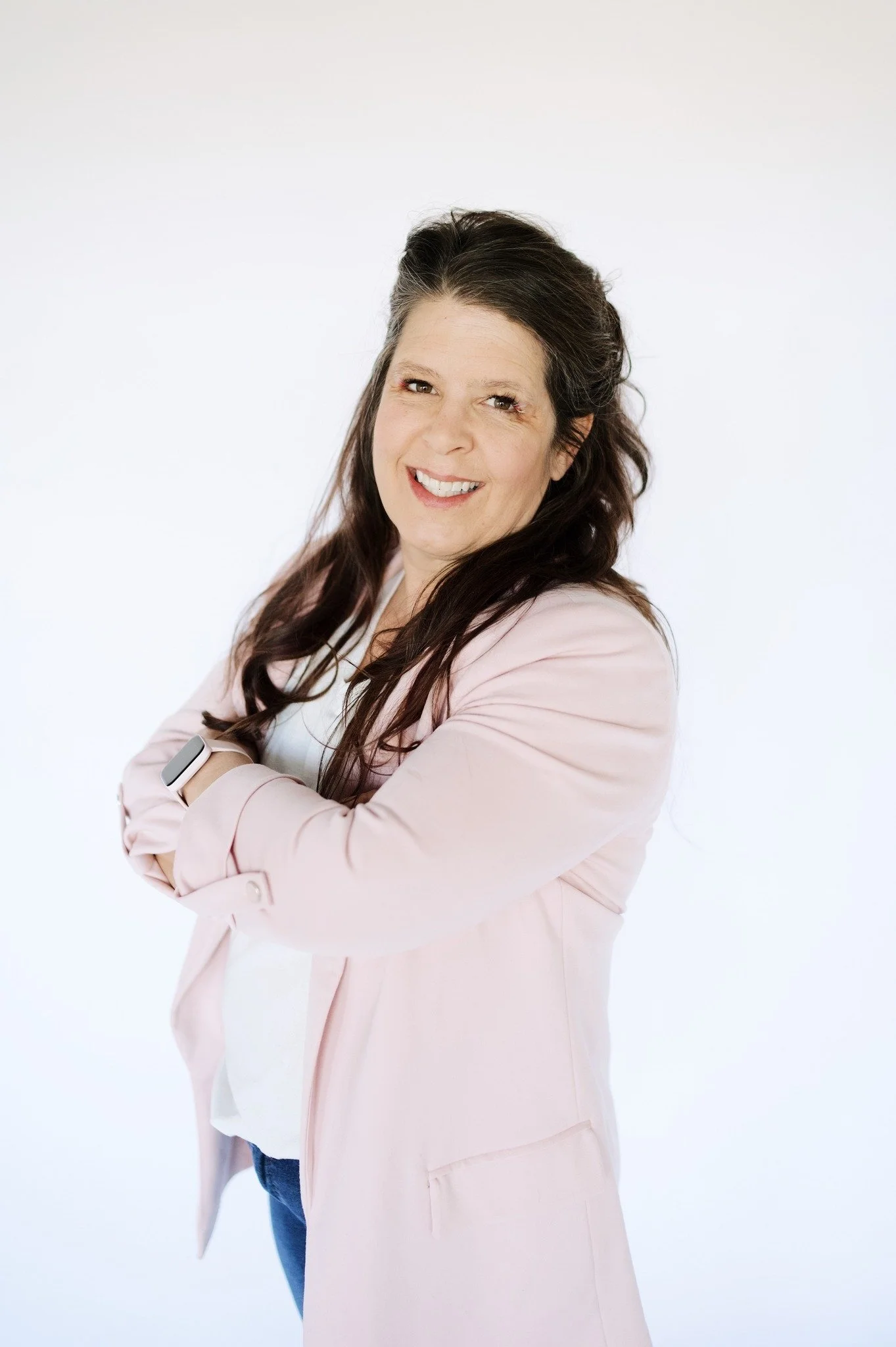 Professional organizer Wendy Dahl of Sugar & Space smiling in a pink blazer.