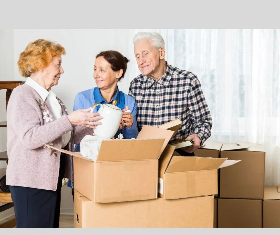 Professional organizer Barb helping a senior couple sort through belongings for downsizing.