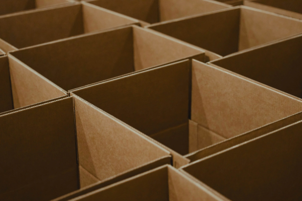 An orderly arrangement of open brown cardboard moving boxes, ready for professional packing by Organized by Keli & Co. in Denver.