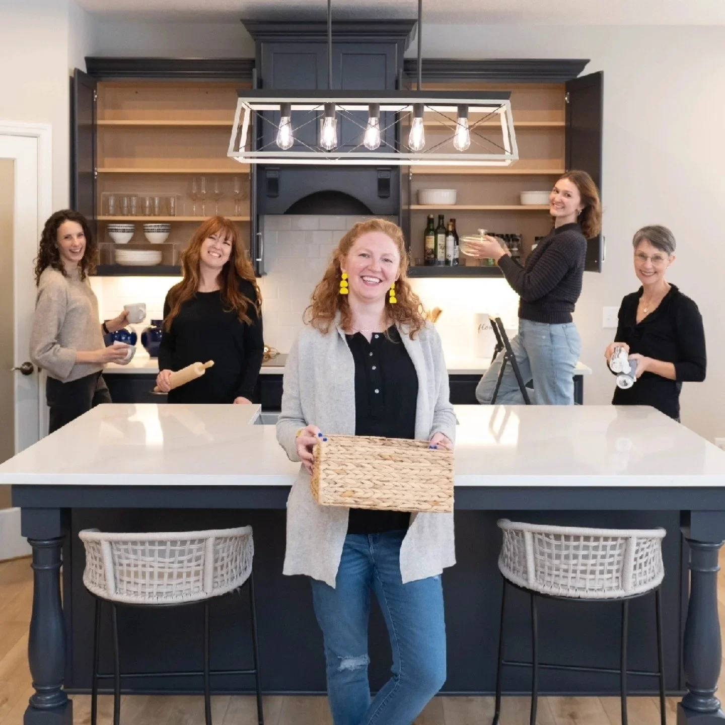 Founder Missi McKown and the Creating Clear Spaces team of professional organizers posing in a modern kitchen.