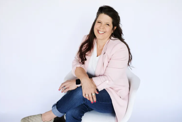 Professional organizer Wendy Dahl of Sugar & Space smiling in a pink blazer. Studio headshot for home organizing services.