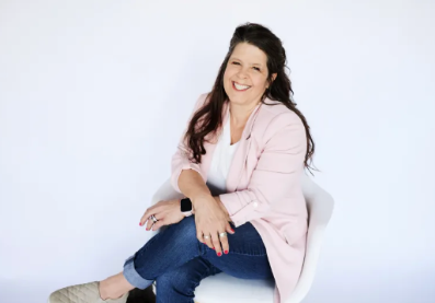 Wendy, professional organizer and founder of Sugar & Space, smiling in a professional studio portrait.