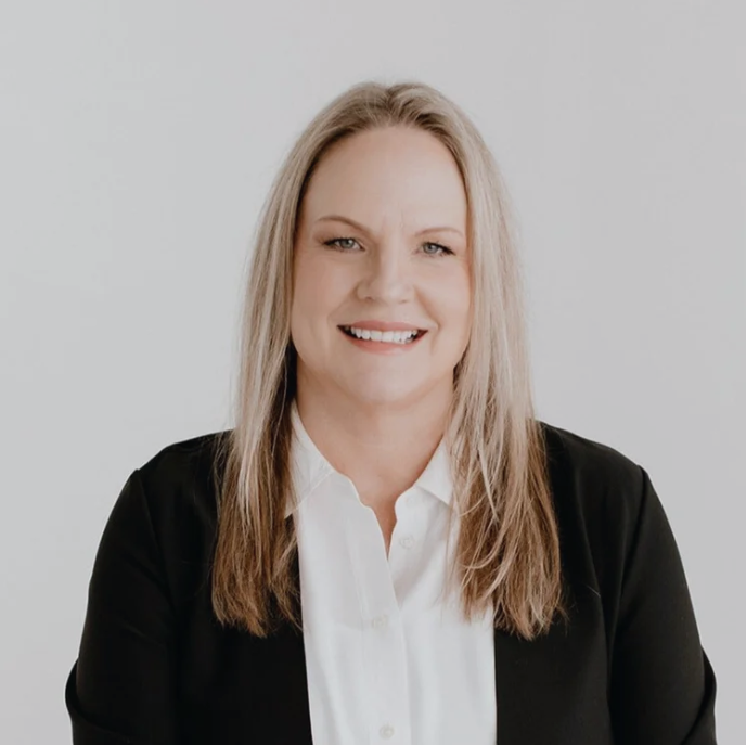 Keli Jakel, founder of Organized by Keli & Co., posing for a professional headshot in a white shirt and black blazer.