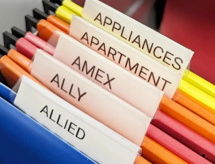 Professional office filing system by Tidy Corners in The Hudson Valley, featuring colorful hanging folders labeled for household and financial documents.