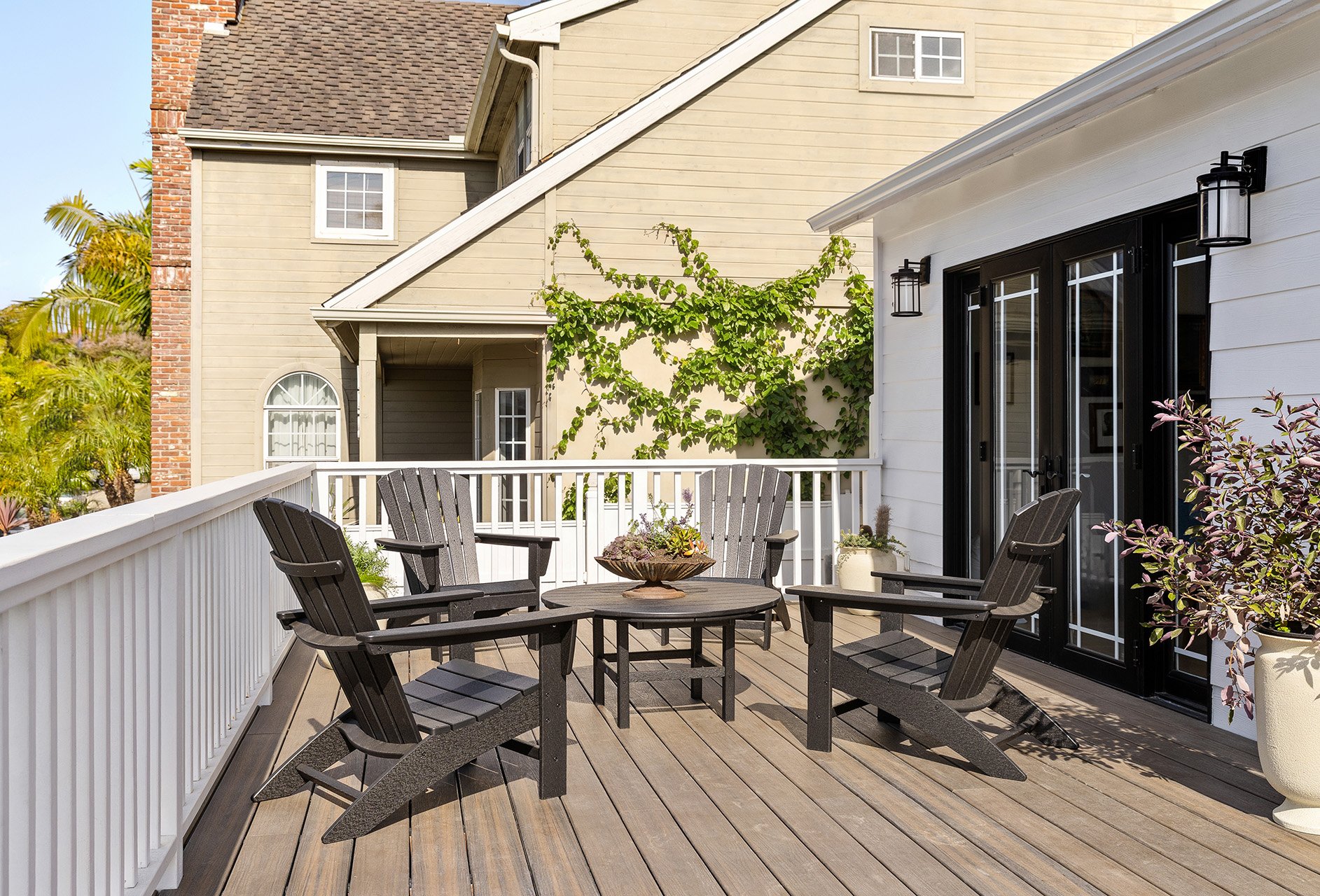 Manhattan Beach deck with durable furniture , graphic lighting and textural plants. 