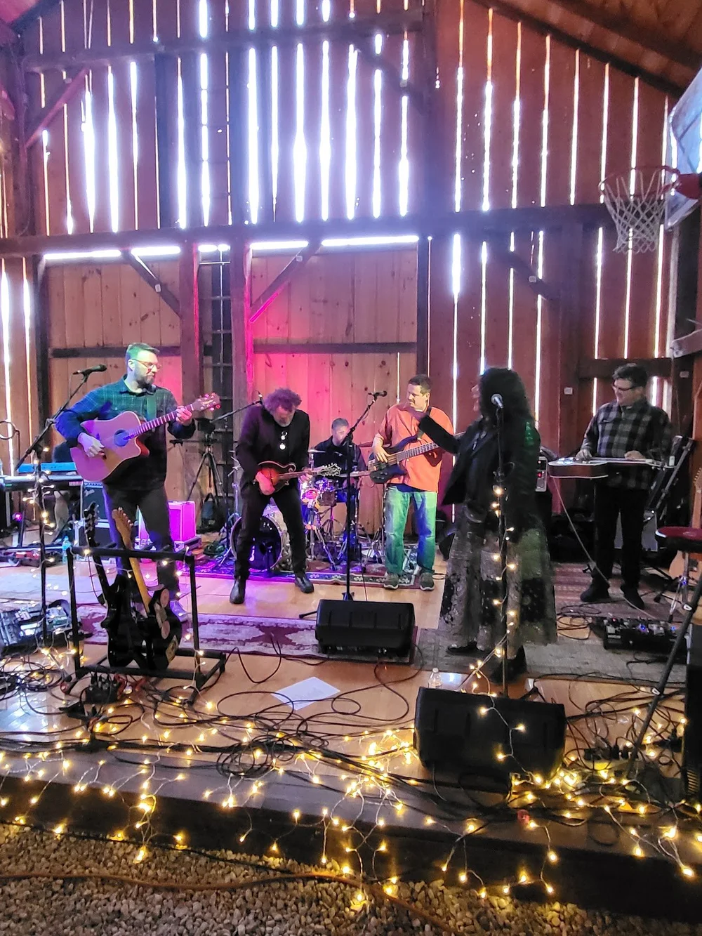 David Andrews Band playing on stage in a rustic barn