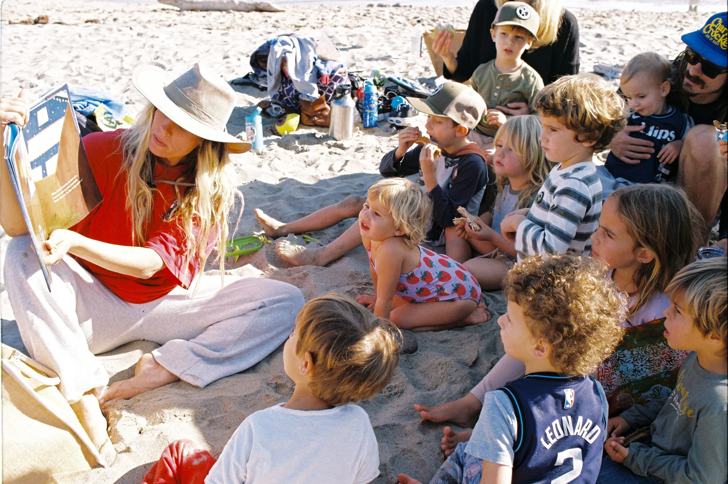 From above hands of unrecognizable woman rubbing aromatic spices into piece of raw meat over parchment paper