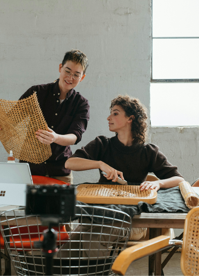 Photo of two people mending an item