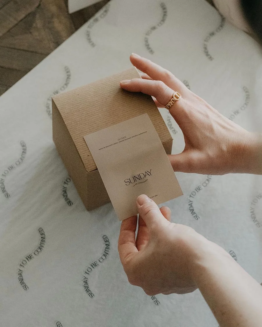 Photo of someone putting a branded label to close an online store box