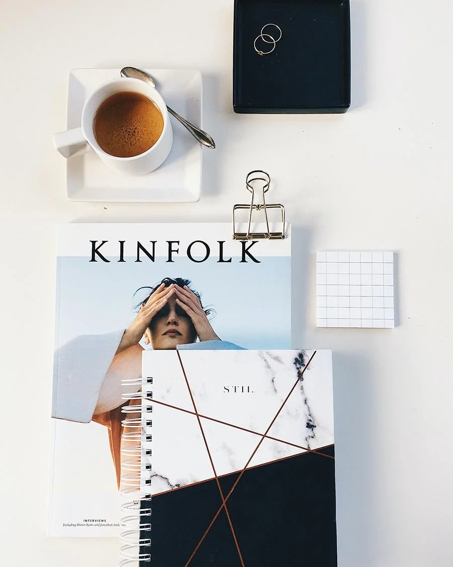 Photo of magazine and notebook laid out on desk