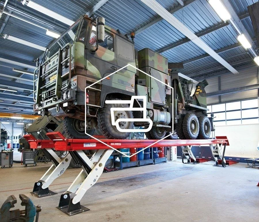 A Stertil EARTHLIFT mobile column lift system raising an articulated truck and trailer