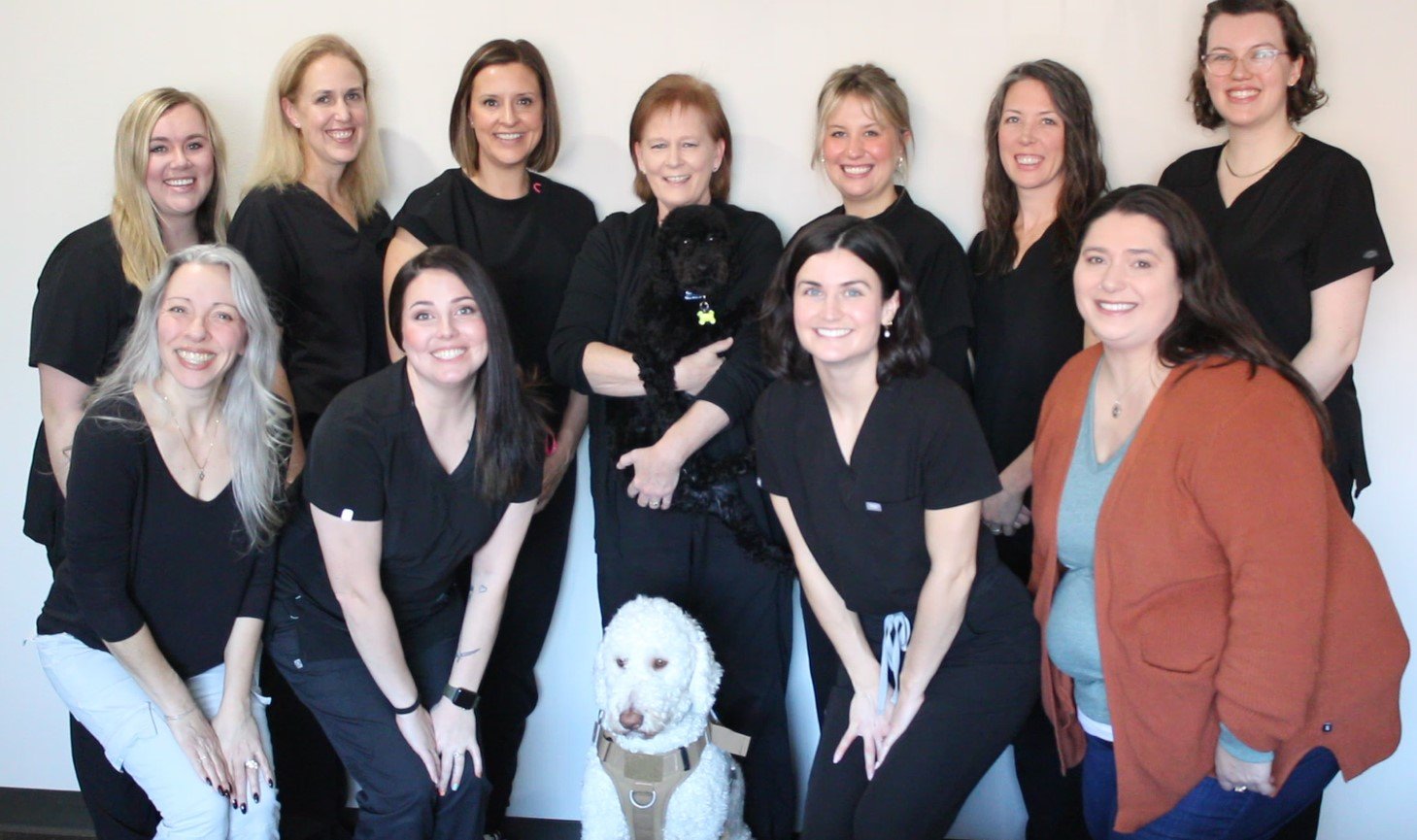 Group of women with two therapy dogs at Enrichment Alternatives.