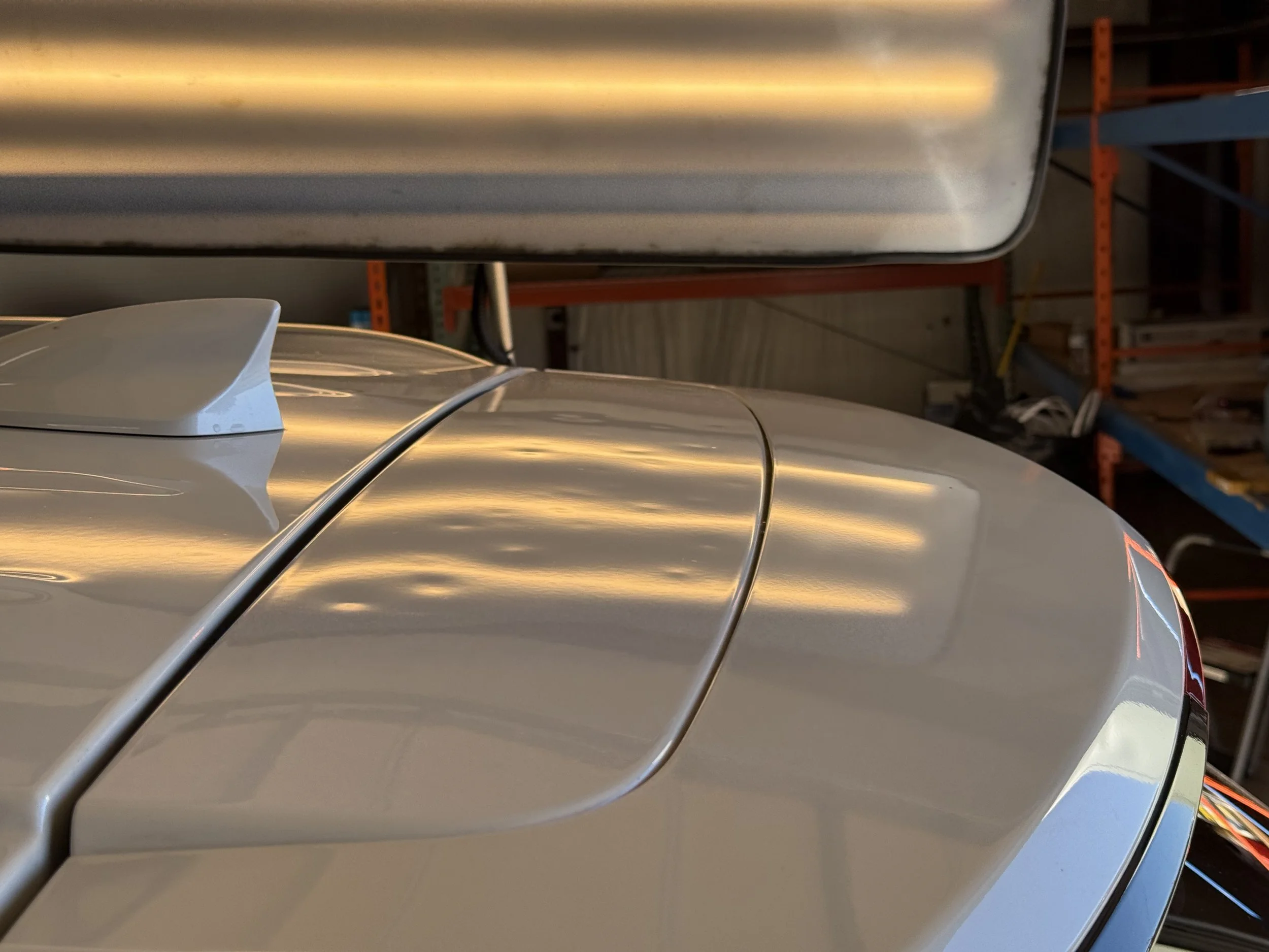 car roof with shark fin antenna in a garage