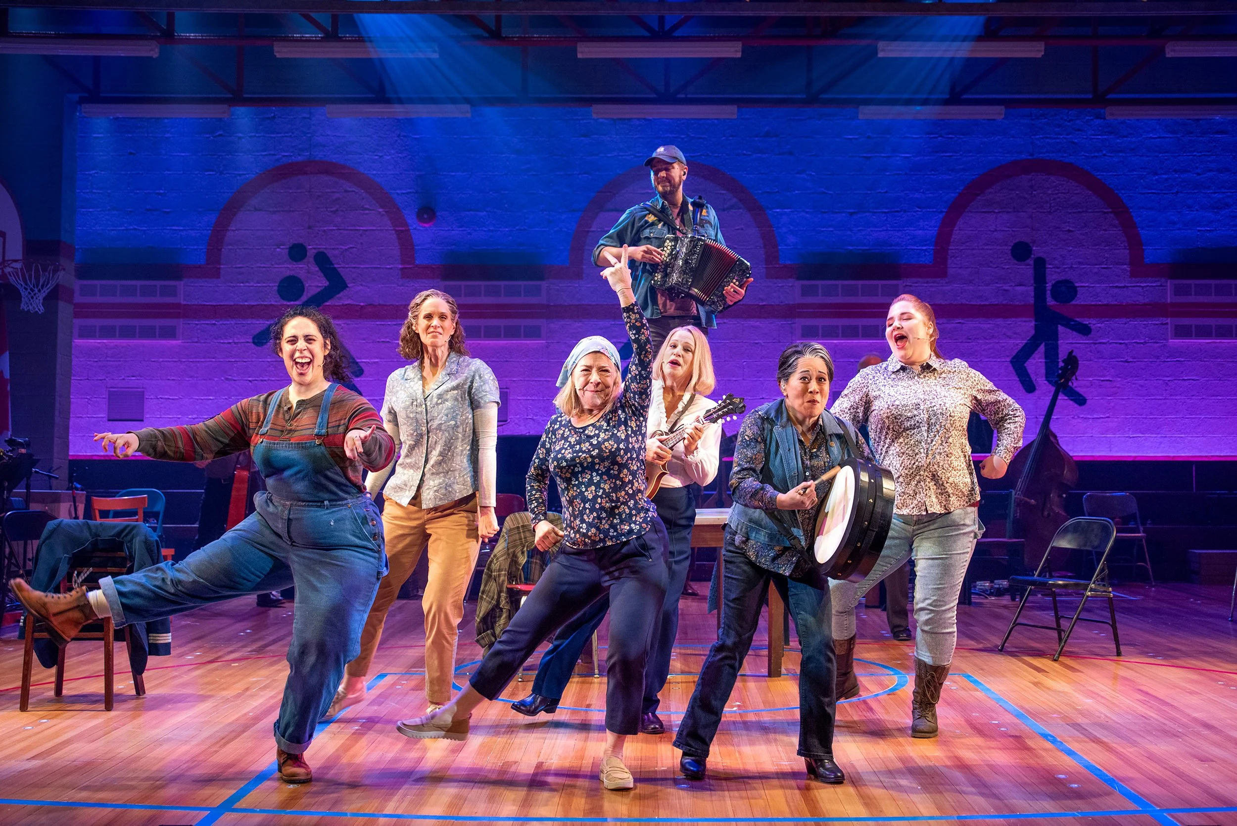 The company of Come From Away (2025) at Seattle Rep. Scenic Design by Timothy Mackabee. Photo by Bronwen Houck.